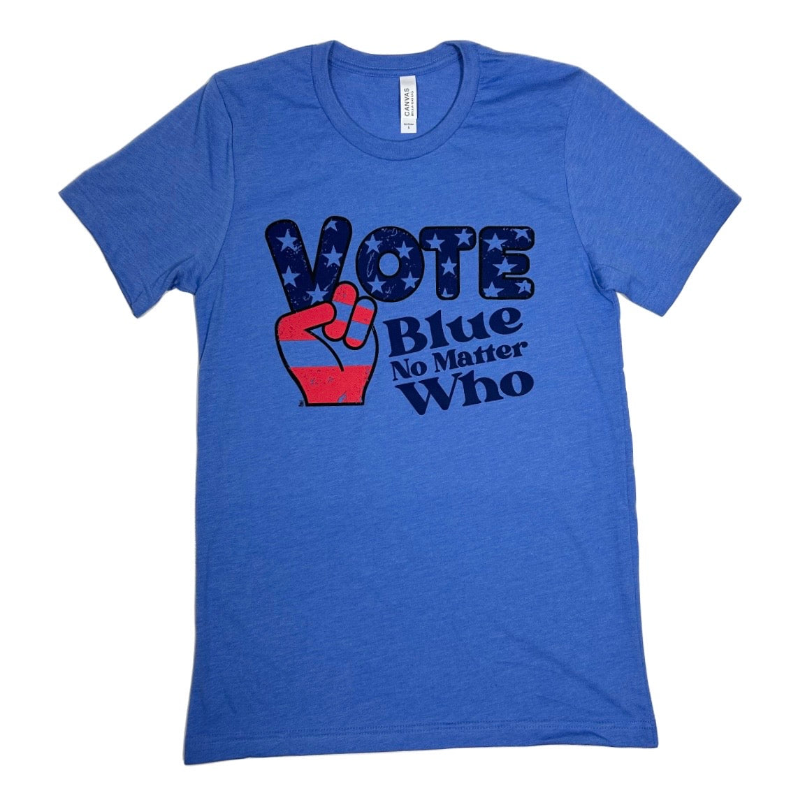 A heather blue short-sleeve t-shirt with a graphic on the front that reads 'VOTE Blue No Matter Who' in dark blue text, featuring a red and blue raised peace sign filled with white stars.